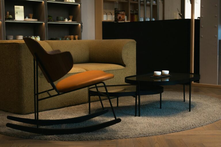 Cozy minimalist interior featuring a beige couch, modern furniture, and elegant decor.